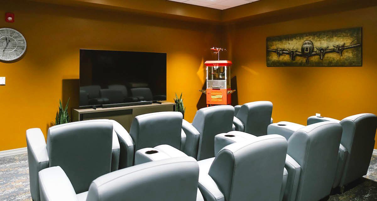 Movie theater with popcorn machine and large chairs